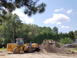 Large rental loader turns compost